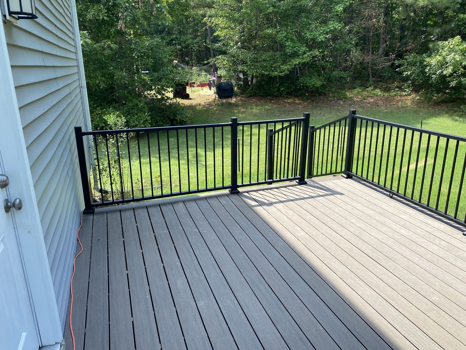 Low-profile composite deck along the back of a home
