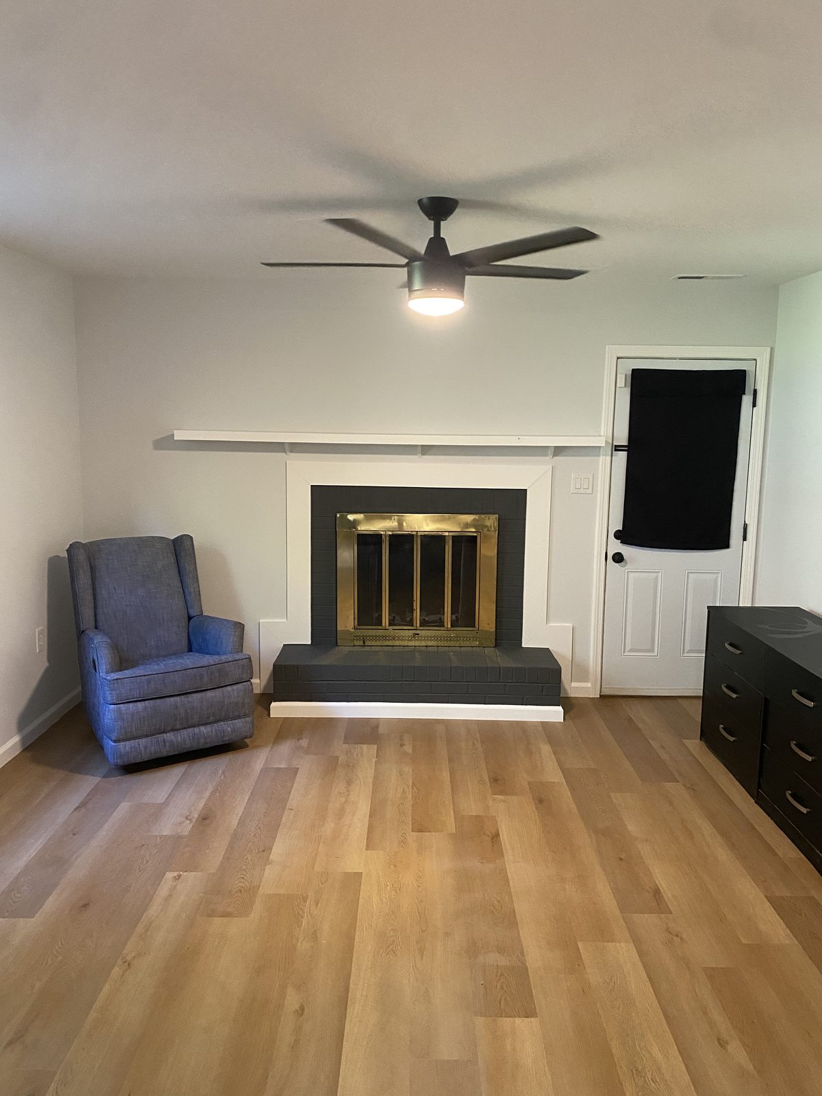 Renovated living room with a fireplace and hardwood floors